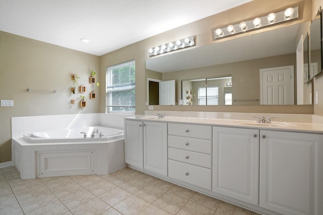 8020 Glenmore Dr, Powell, OH 43065 - bathroom with double vanity, a garden tub, and tile patterned floors