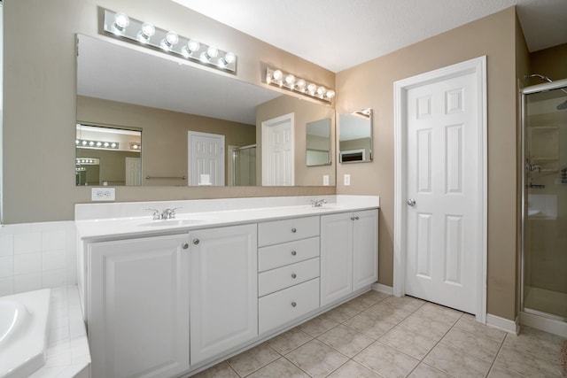 8020 Glenmore Dr, Powell, OH 43065 - bathroom featuring double vanity, a shower stall, tile patterned floors, and a garden tub