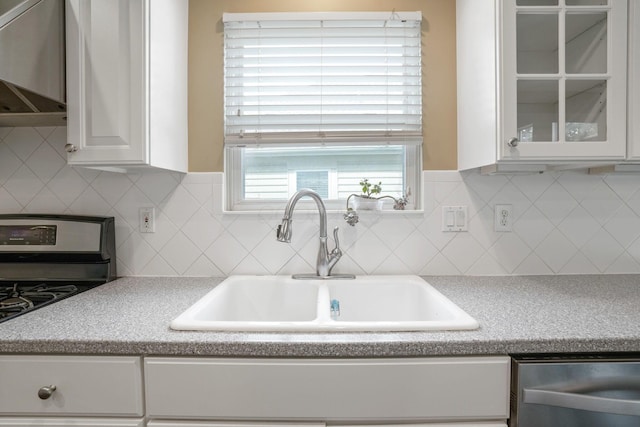 8020 Glenmore Dr, Powell, OH 43065 - kitchen featuring appliances with stainless steel finishes, white cabinets, glass insert cabinets, and light countertops