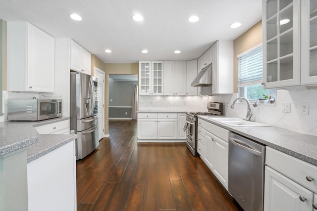 8020 Glenmore Dr, Powell, OH 43065 - kitchen featuring stainless steel appliances, under cabinet range hood, dark wood-style flooring, white cabinets, and recessed lighting