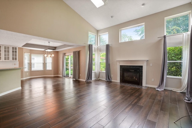 8020 Glenmore Dr, Powell, OH 43065 - unfurnished living room featuring a fireplace, a chandelier, wood finished floors, and high vaulted ceiling