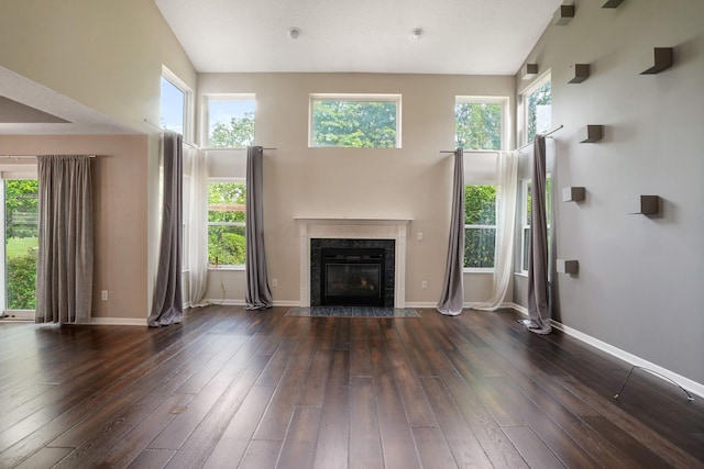 8020 Glenmore Dr, Powell, OH 43065 - unfurnished living room featuring hardwood / wood-style floors, a premium fireplace, and a towering ceiling