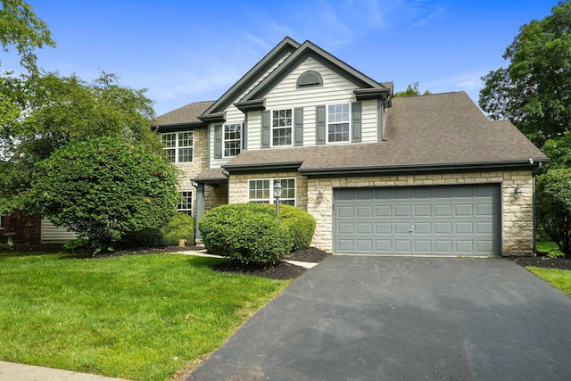 8020 Glenmore Dr, Powell, OH 43065 - view of front facade with stone siding, driveway, a front lawn, a shingled roof, and a garage