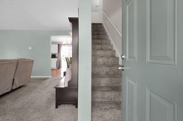 3101 Lewis Rd, Columbus, OH 43207 - stairs with a chandelier and carpet