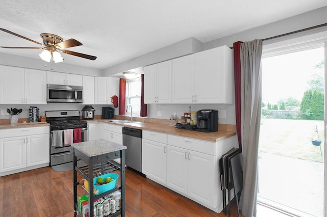 3101 Lewis Rd, Columbus, OH 43207 - kitchen featuring stainless steel appliances, light countertops, ceiling fan, white cabinets, and a textured ceiling