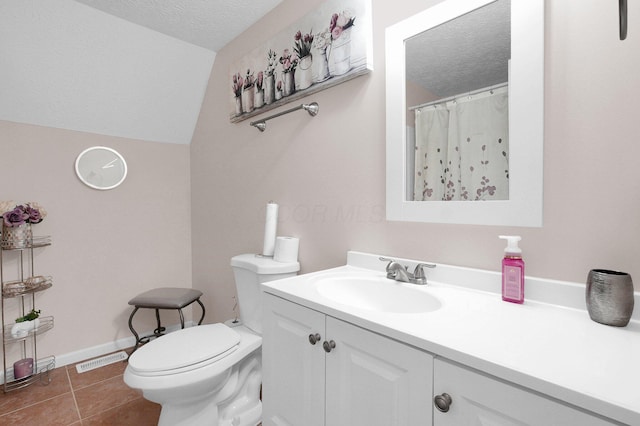 3101 Lewis Rd, Columbus, OH 43207 - bathroom with a textured ceiling, vanity, tile patterned floors, and vaulted ceiling