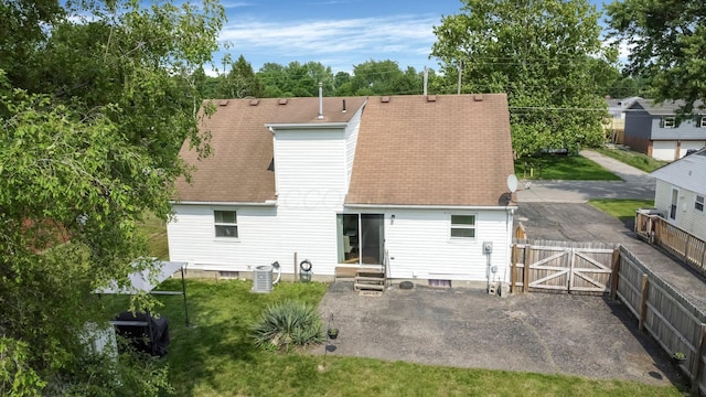 3101 Lewis Rd, Columbus, OH 43207 - back of property with a gate, roof with shingles, entry steps, and a patio area