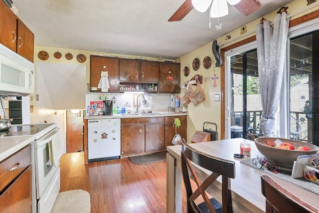 718 Bradwell Dr, Columbus, OH 43207 - kitchen with white appliances, light wood-type flooring, a ceiling fan, light countertops, and tasteful backsplash