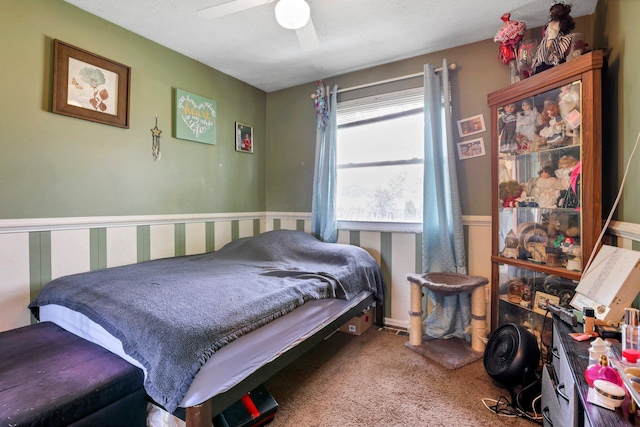 718 Bradwell Dr, Columbus, OH 43207 - carpeted bedroom with wainscoting and a ceiling fan