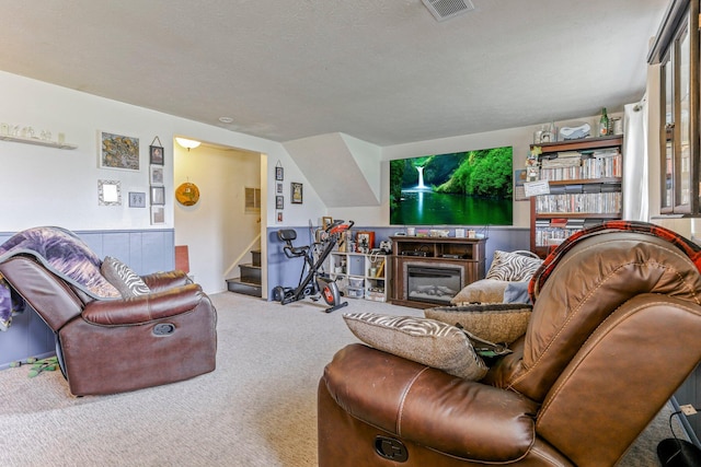 718 Bradwell Dr, Columbus, OH 43207 - carpeted living room featuring stairs and a glass covered fireplace