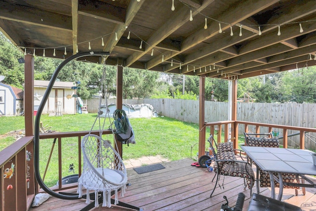 718 Bradwell Dr, Columbus, OH 43207 - wooden terrace featuring a fenced backyard, a shed, and outdoor dining space