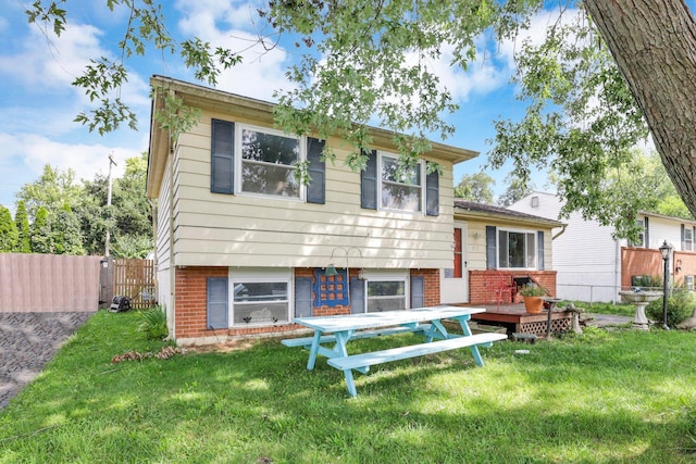 718 Bradwell Dr, Columbus, OH 43207 - split level home with brick siding and a deck