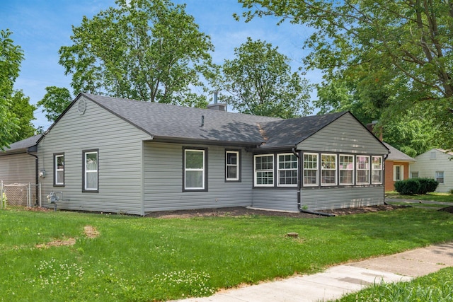 340 Danhurst Rd, Columbus, OH 43228 - rear view of house featuring a shingled roof, a chimney, a yard, and a sunroom