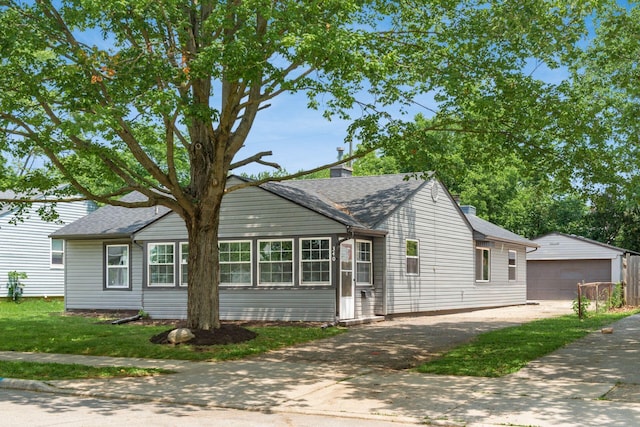 340 Danhurst Rd, Columbus, OH 43228 - view of front of home featuring an outbuilding, a detached garage, and a chimney