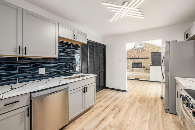 340 Danhurst Rd, Columbus, OH 43228 - kitchen with appliances with stainless steel finishes, tasteful backsplash, light stone countertops, and a chandelier