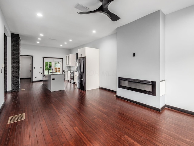 241 N 17th St, Columbus, OH 43203 - unfurnished living room featuring a ceiling fan, dark wood-style floors, recessed lighting, and heating unit