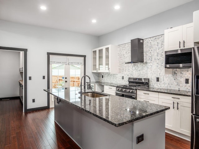 241 N 17th St, Columbus, OH 43203 - kitchen with appliances with stainless steel finishes, wall chimney range hood, dark stone counters, backsplash, and recessed lighting