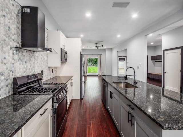 241 N 17th St, Columbus, OH 43203 - kitchen featuring stainless steel appliances, wall chimney range hood, ceiling fan, dark wood-style floors, and recessed lighting