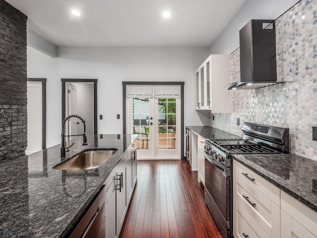 241 N 17th St, Columbus, OH 43203 - kitchen featuring stainless steel appliances, wall chimney range hood, french doors, tasteful backsplash, and dark wood-type flooring