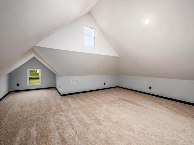 241 N 17th St, Columbus, OH 43203 - additional living space with lofted ceiling, carpet floors, and healthy amount of natural light