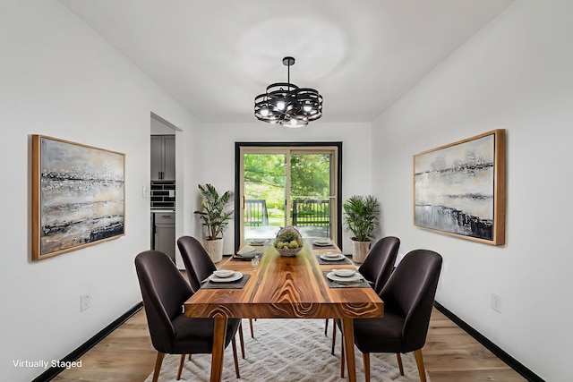 1908 Lost Valley Rd, Powell, OH 43065 - dining space featuring a chandelier and light wood-style floors