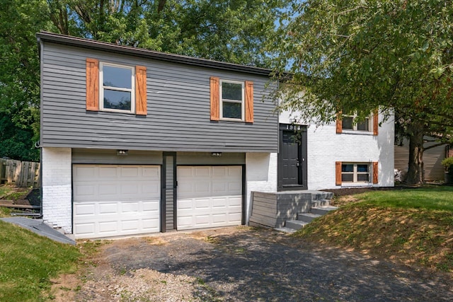 1908 Lost Valley Rd, Powell, OH 43065 - raised ranch with brick siding, an attached garage, and driveway
