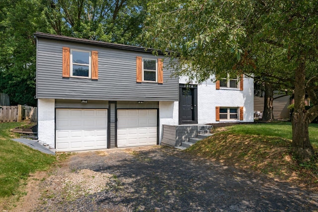 1908 Lost Valley Rd, Powell, OH 43065 - split foyer home featuring brick siding, a garage, and asphalt driveway