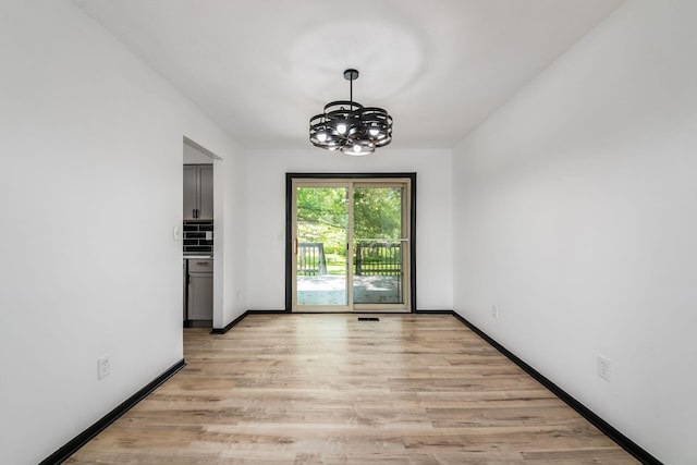 1908 Lost Valley Rd, Powell, OH 43065 - unfurnished dining area with a chandelier and light wood finished floors
