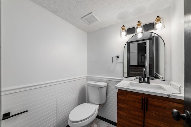 1908 Lost Valley Rd, Powell, OH 43065 - bathroom featuring wainscoting, vanity, and a textured ceiling