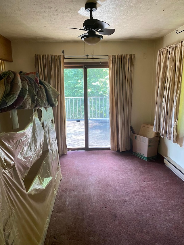 12170 Fairview Rd SE, Heath, OH 43056 - carpeted bedroom featuring access to exterior, a textured ceiling, a ceiling fan, and baseboard heating