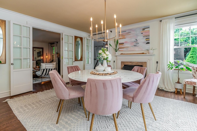 233 Preston Rd, Columbus, OH 43209 - dining room with a fireplace, a chandelier, ornamental molding, and wood finished floors