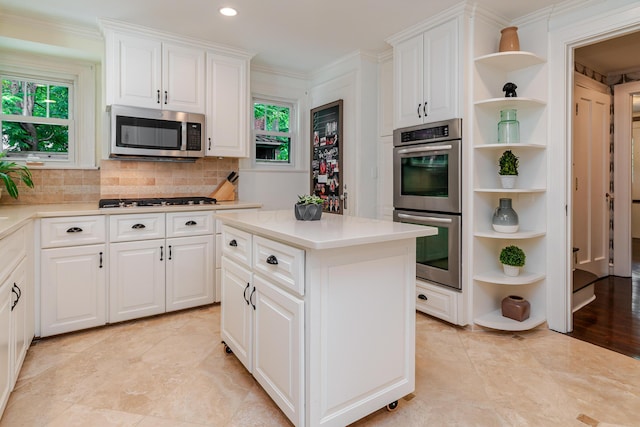 233 Preston Rd, Columbus, OH 43209 - kitchen with open shelves, stainless steel appliances, healthy amount of natural light, crown molding, and recessed lighting