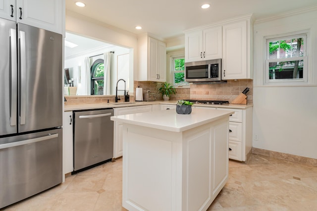 233 Preston Rd, Columbus, OH 43209 - kitchen featuring appliances with stainless steel finishes, crown molding, backsplash, white cabinets, and light countertops