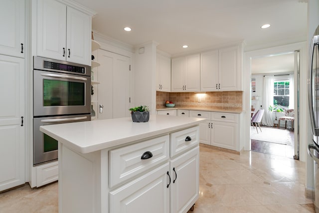 233 Preston Rd, Columbus, OH 43209 - kitchen featuring stainless steel double oven, backsplash, light countertops, white cabinetry, and recessed lighting