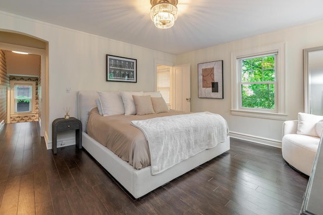 233 Preston Rd, Columbus, OH 43209 - bedroom with multiple windows, arched walkways, dark wood-style floors, and a chandelier