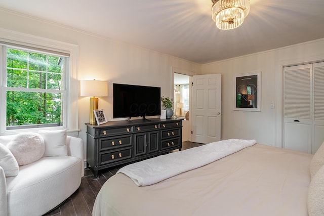 233 Preston Rd, Columbus, OH 43209 - bedroom featuring dark wood-style floors, ornamental molding, a closet, and a chandelier