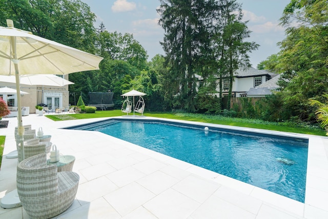 233 Preston Rd, Columbus, OH 43209 - swimming pool featuring french doors, a trampoline, a patio, and a lawn