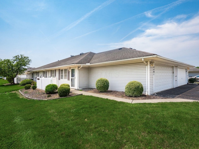 4401 Hammerton Dr Unit 13A, Columbus, OH 43228 - view of side of home with a lawn, asphalt driveway, and an attached garage