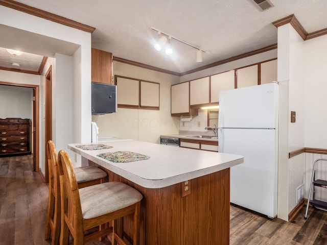 4401 Hammerton Dr Unit 13A, Columbus, OH 43228 - kitchen featuring freestanding refrigerator, light countertops, dark wood-style flooring, ornamental molding, and rail lighting