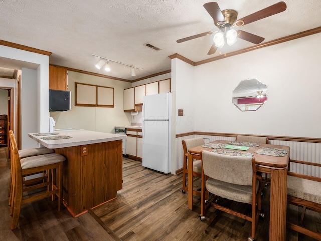 4401 Hammerton Dr Unit 13A, Columbus, OH 43228 - kitchen with freestanding refrigerator, dark wood-type flooring, a peninsula, light countertops, and ornamental molding