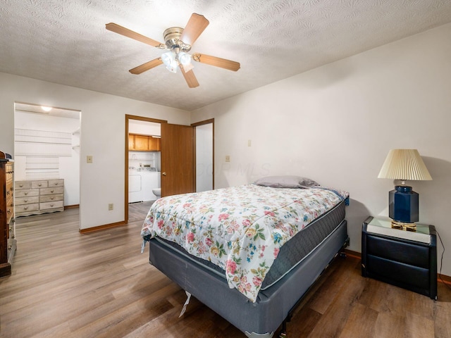 4401 Hammerton Dr Unit 13A, Columbus, OH 43228 - bedroom featuring washing machine and clothes dryer, wood finished floors, a textured ceiling, and a ceiling fan