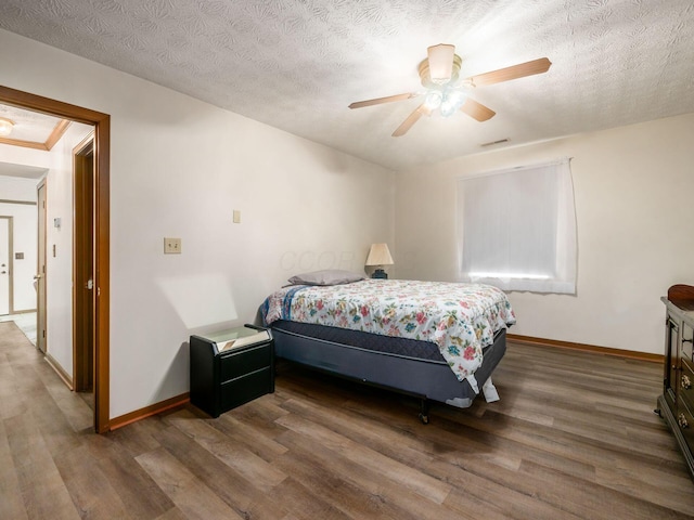 4401 Hammerton Dr Unit 13A, Columbus, OH 43228 - bedroom featuring wood finished floors, a textured ceiling, and ceiling fan