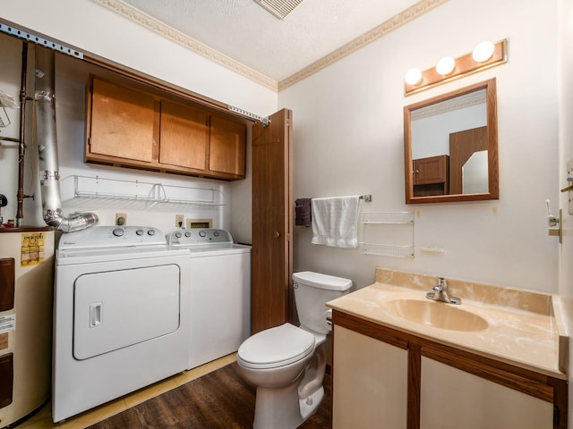 4401 Hammerton Dr Unit 13A, Columbus, OH 43228 - bathroom featuring electric water heater, washing machine and clothes dryer, vanity, wood finished floors, and a textured ceiling