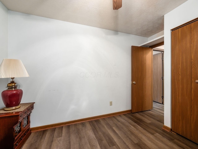 4401 Hammerton Dr Unit 13A, Columbus, OH 43228 - unfurnished bedroom with wood finished floors, a closet, a ceiling fan, and a textured ceiling