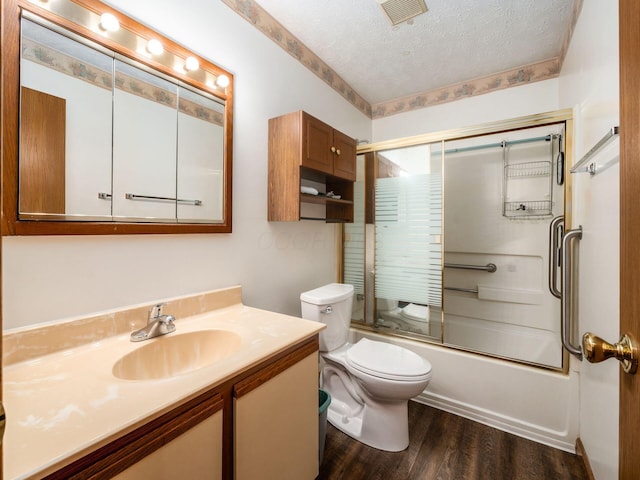 4401 Hammerton Dr Unit 13A, Columbus, OH 43228 - full bath featuring vanity, wood finished floors, enclosed tub / shower combo, and a textured ceiling