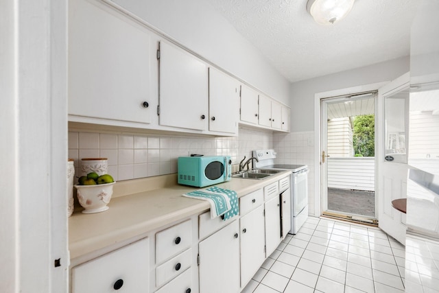 4388 Allen Dr, Columbus, OH 43213 - kitchen with white appliances, light countertops, white cabinets, light tile patterned floors, and a textured ceiling