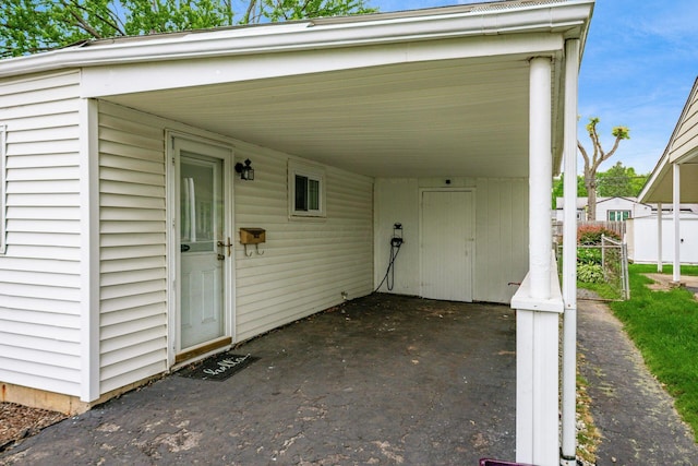 4388 Allen Dr, Columbus, OH 43213 - view of exterior entry featuring a carport and asphalt driveway