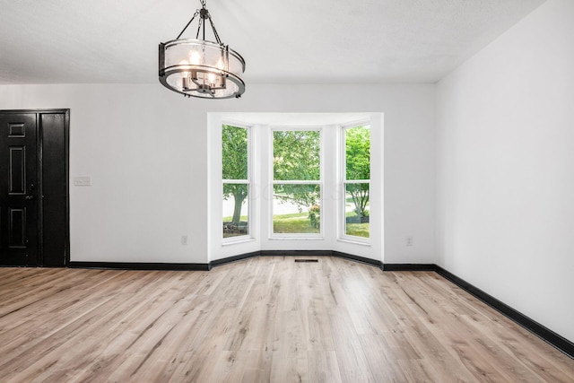 2840 Harnet Ct, Columbus, OH 43231 - spare room with a chandelier and wood finished floors