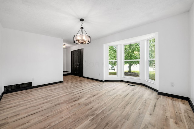 2840 Harnet Ct, Columbus, OH 43231 - unfurnished dining area featuring wood finished floors and a chandelier