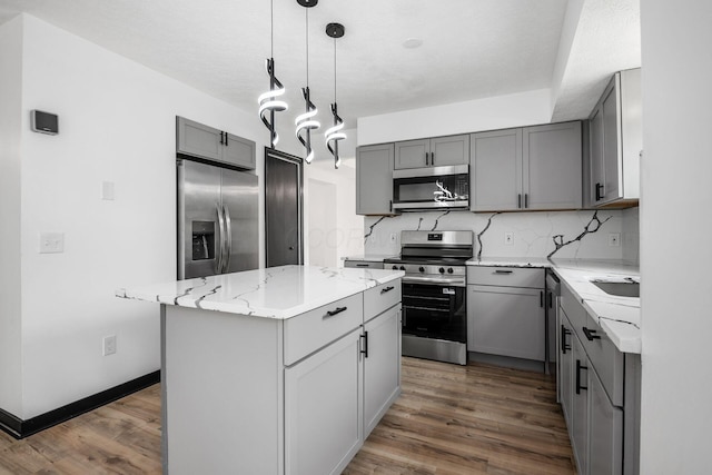 2840 Harnet Ct, Columbus, OH 43231 - kitchen featuring appliances with stainless steel finishes, gray cabinets, dark wood-style flooring, light stone countertops, and backsplash